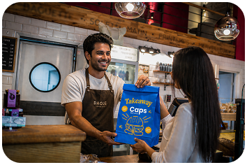 Happy customer receiving CAPS takeaway order